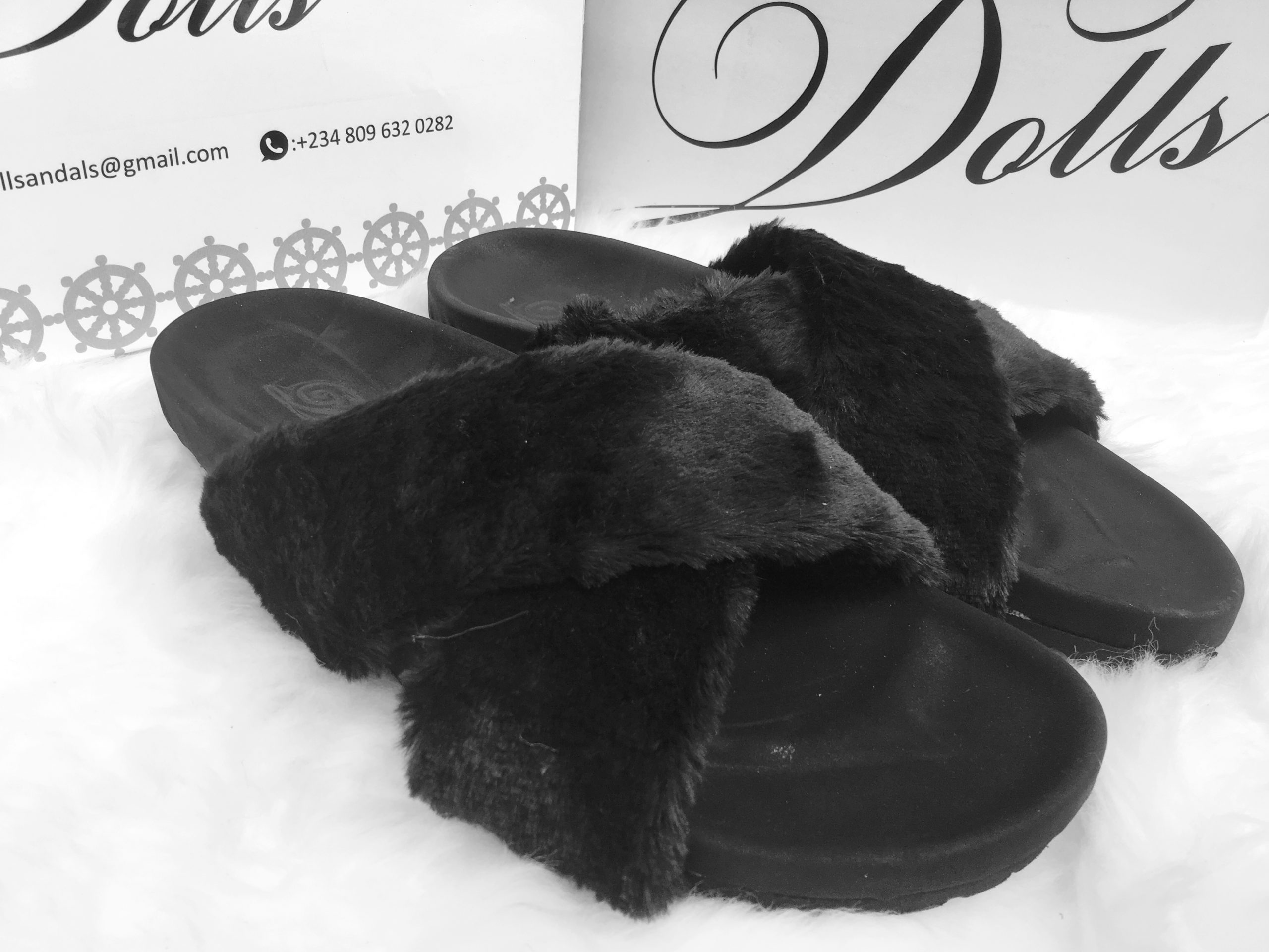 picture of a pair of unisex fur slides by Dolls leather products